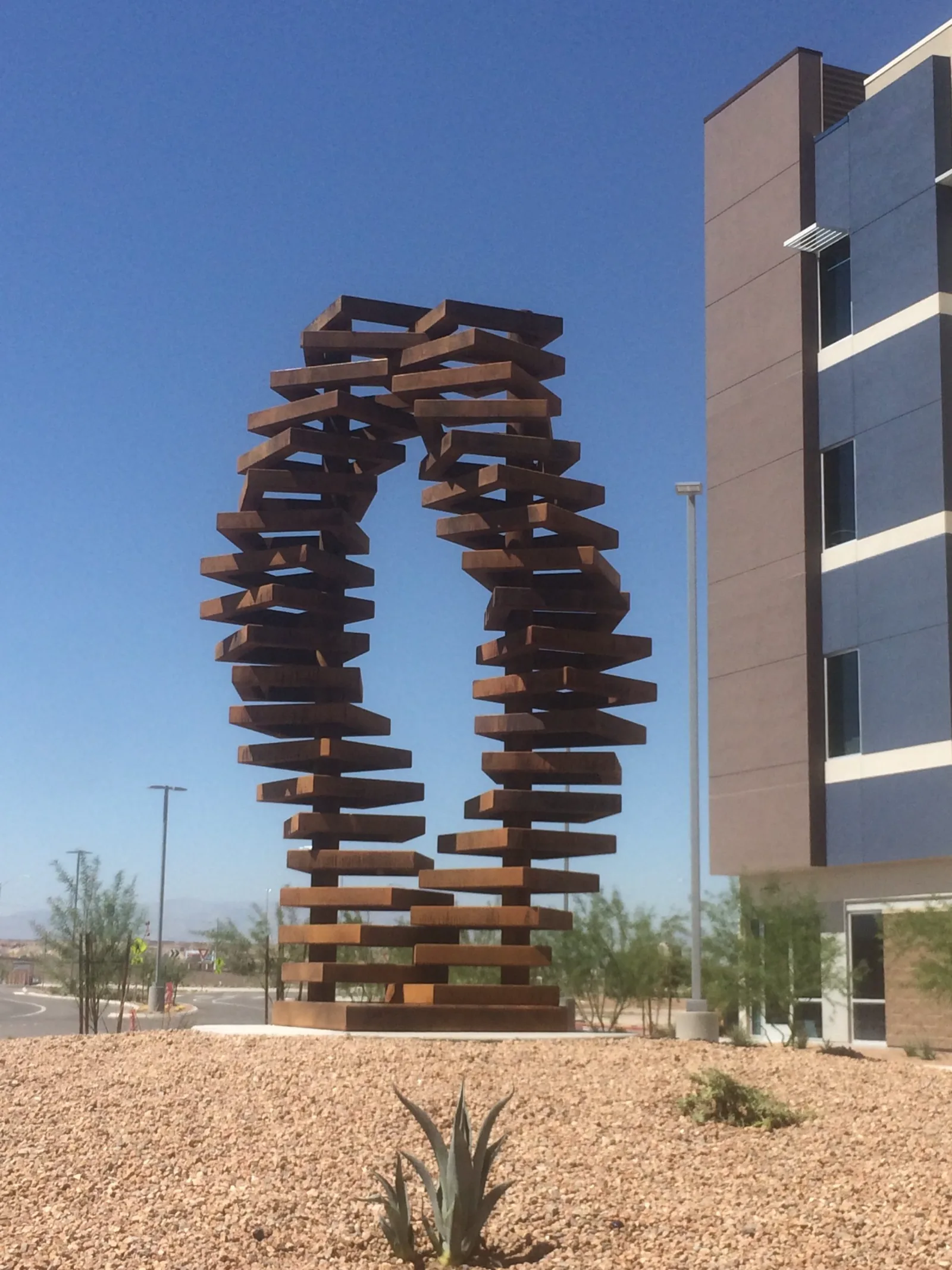 Overcome, two aged steel helix forms, 10 feet tall